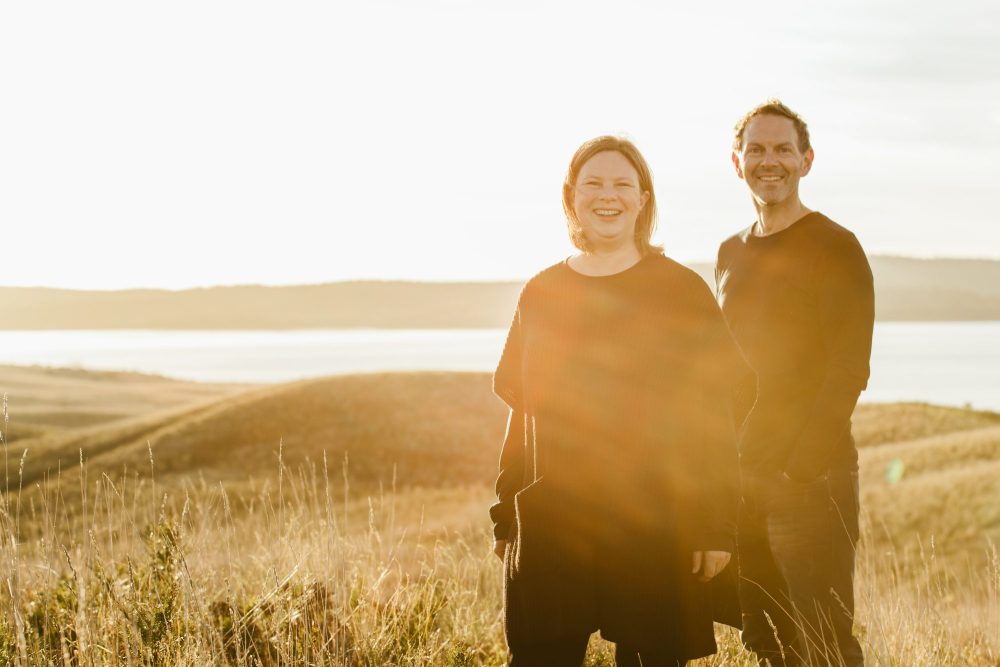Karryn Dargie and Dean Baird with gthe sun rising behind them on Arm End.